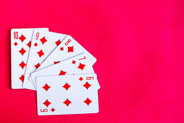 Poker straight flush playing card, top view, red background - Foto, imagen