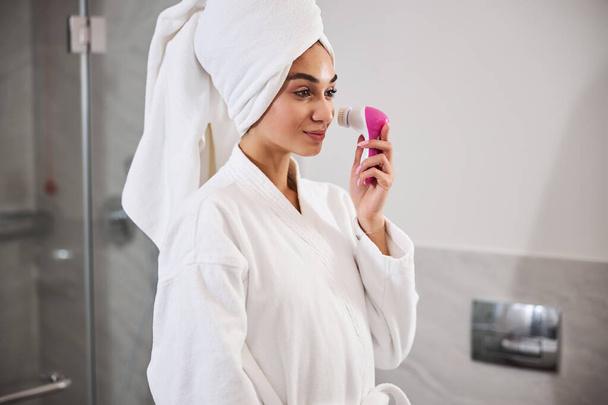 Beautiful young woman doing facial massage after shower - Fotó, kép
