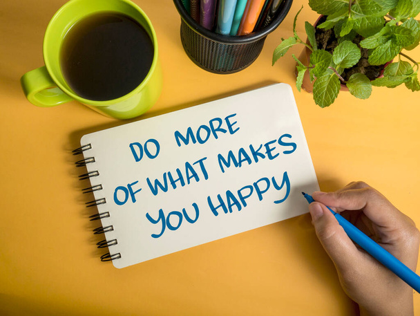 Do more of what makes you happy, text words typography written on book against yellow background, life and business motivational inspirational concept - Foto, immagini
