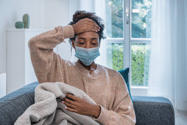 Black girl having flu, feeling bad and lying on the sofa - Фото, изображение