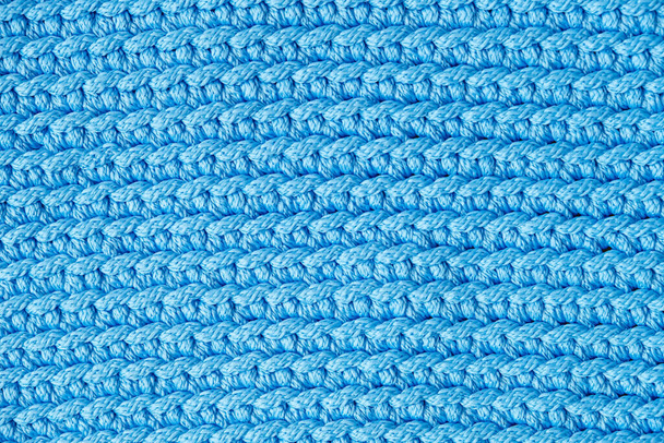 Blue knitted fabric texture background. Top view. Copy, empty space for text. - Photo, Image