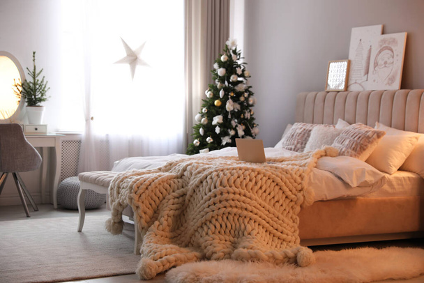 Beautiful decorated Christmas tree in bedroom interior - Фото, зображення