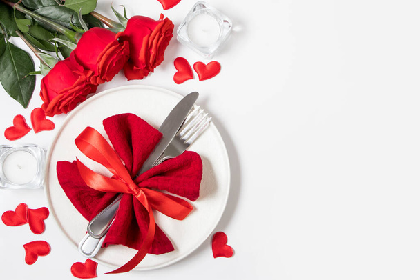 Valentine's day romantic dinner concept. Beautiful table setting. Roses and candles on white background. - Foto, Bild
