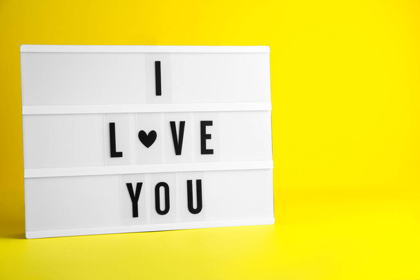 Decorative lightbox with phrase I love You on yellow background. Space for text - Photo, image