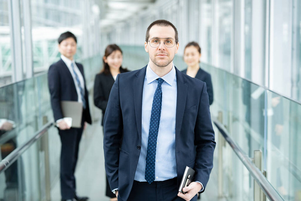 Businessman and his business team standing at office area - Photo, Image
