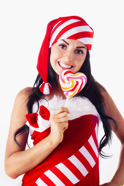 Santa girl holding a lollipop. Holidays Christmas And New Year. - Fotó, kép