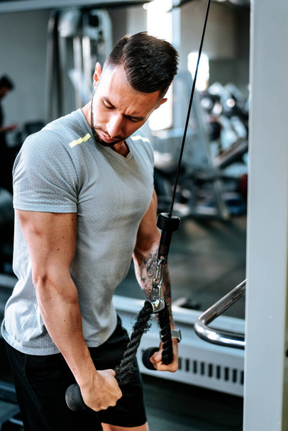 handsome strong athletic man working triceps muscles. workout fitness and bodybuilding healthy concept - Foto, Imagem