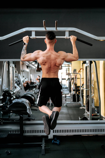 Athletic shirtless sports man training - fitness model in gym - Фото, зображення