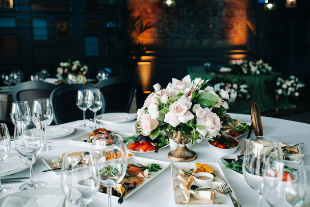 wedding table decoration with flowers on the table in the castle, table decor for dinner by candlelight.Dinner with candles. - Foto, Bild