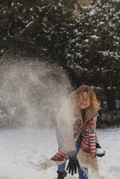 Блондинка Кавказька кидає сніг, насолоджуючись зимою. - Фото, зображення