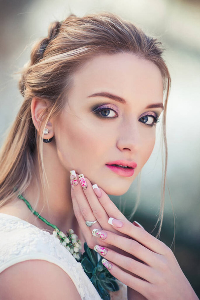 Spring attractive woman outdoors portrait. Romantic sensual lady with beautiful nails. Femininity and beauty concept - Zdjęcie, obraz