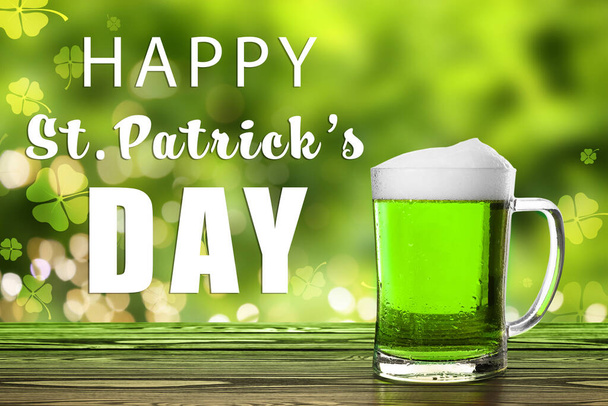 Happy St. Patrick's Day. Tasty green beer on wooden table - Zdjęcie, obraz