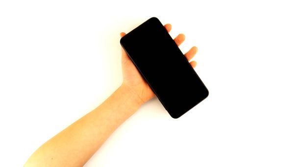 Kézben tartja fekete okostelefon elszigetelt fehér háttér - Fotó, kép