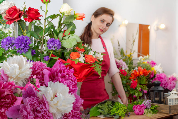 Crop view saller of flowers. Floristic business.DIY arrangement of bouquets. - Photo, Image