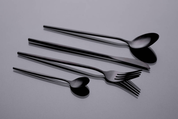 Cutlery on a gray background with shadow. Table serving. Preparing for Dinner - Фото, изображение