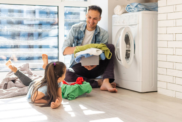 happy casual multiethnic family laundry clothes at home - 写真・画像