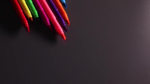 Bright multicolored markers rolling on black background. Art, pain, write, stationery, felt tip. High quality FullHD footage - Footage, Video