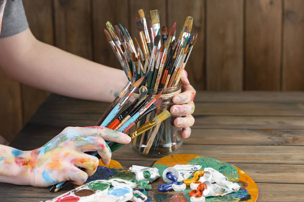 Woman's hand with paint brush. - Zdjęcie, obraz