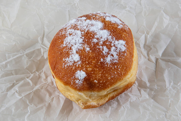 Verse gebakken en gegarneerd met poedersuiker Duitse donuts - Berliner of Krapfen - op witte tafel. - Foto, afbeelding