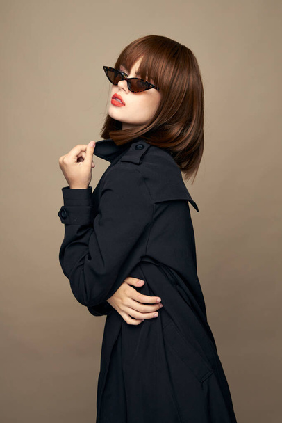 Funny model dark coat attractive appearance rejoicing on an isolated background  - Foto, Imagem