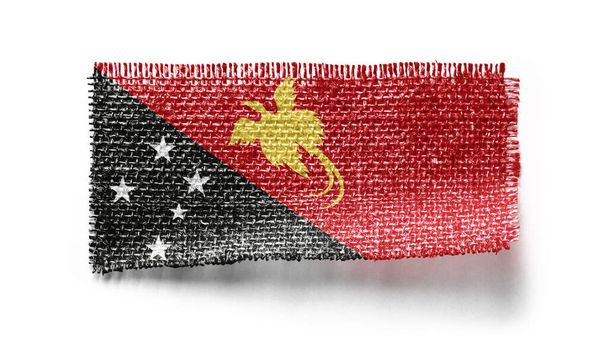 Papua New Guinea flag on a piece of cloth on a white background - Photo, Image