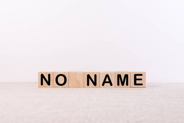 NO NAME word concept written on wooden cubes blocks lying on a light table and light background - Fotoğraf, Görsel