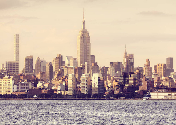 New York City skyline at golden sunset, color toned picture, USA. - Foto, imagen