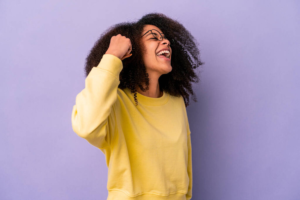 Young african american curly woman isolated on purple background celebrating a victory, passion and enthusiasm, happy expression. - Foto, imagen