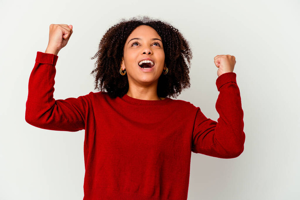 Young african american mixed race woman isolated raising fist after a victory, winner concept. - Fotoğraf, Görsel