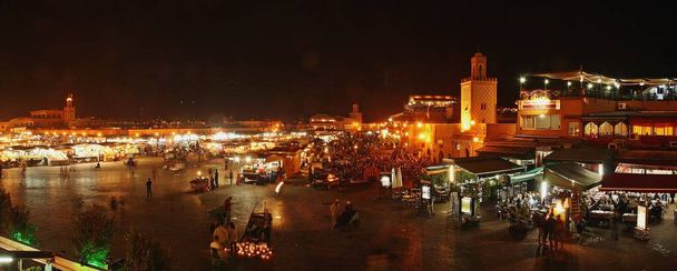 Ночь на площади Марракеша. Джемаа Эль Фна площади, где туристы и местные жители делят пространство. - Фото, изображение