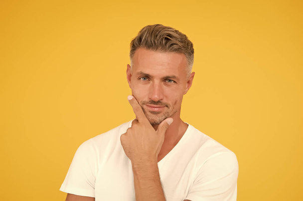 Ask barber to shave. Serious man touch beard hair yellow background. Handsome guy with unshaven face. Beard barber. Barber services. Barber shop. Male grooming. Skincare and haircare. Barbershop - Foto, Imagen