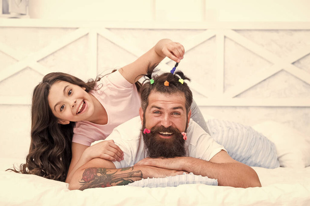 Pajamas party. Happy childhood. Upbringing happy daughter. Relaxing in bedroom. Family leisure concept. Girl dad hairdo. Quarantine with children. Affection and support. Happy family. Role of father - Photo, Image