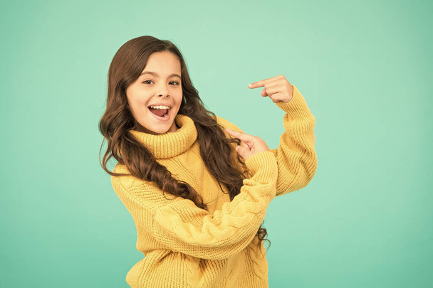 Look there. Pure beauty of baby girl. Small girl with long brunette hair. child in casual winter fashion style. knitting for kids. Little girl on blue background. Childhood and girlhood - Zdjęcie, obraz
