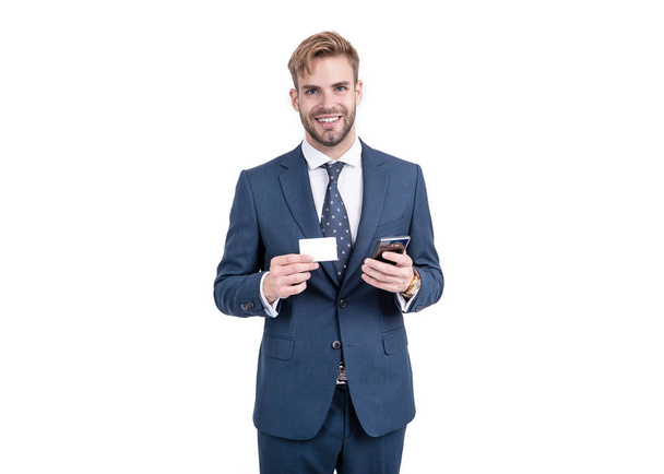 Happy manager in formal suit hold mobile phone and identity card for copy space, identification - Foto, imagen
