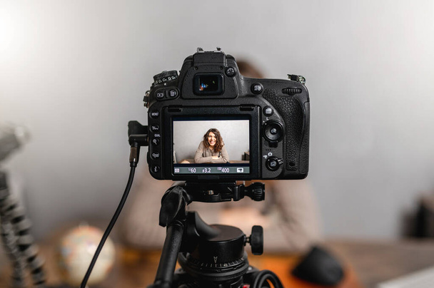 A closeup shot of a camera setup by a Caucasian female video blogger while filming a blog - Foto, Bild