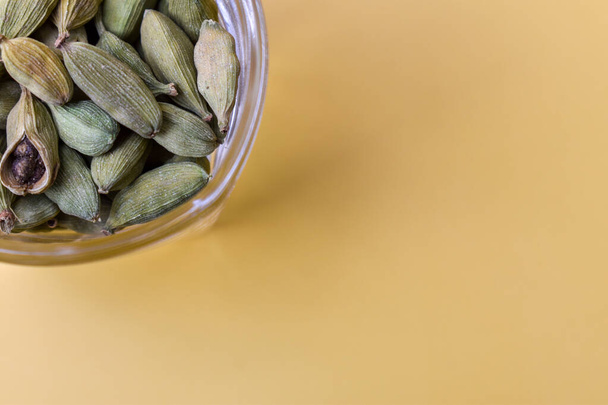 A closeup of the cardamom seeds in a glass bowl - Photo, image