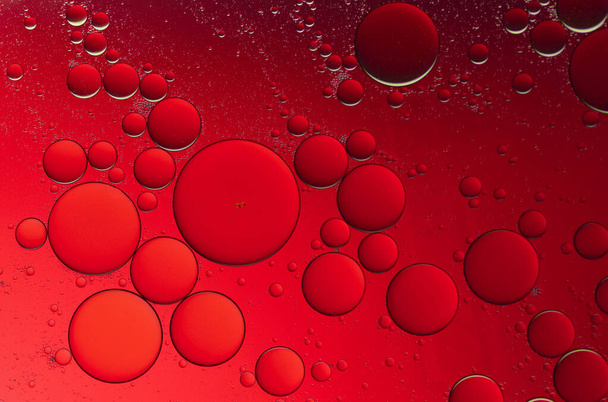 Dark red water droplets on a red backgro - Zdjęcie, obraz