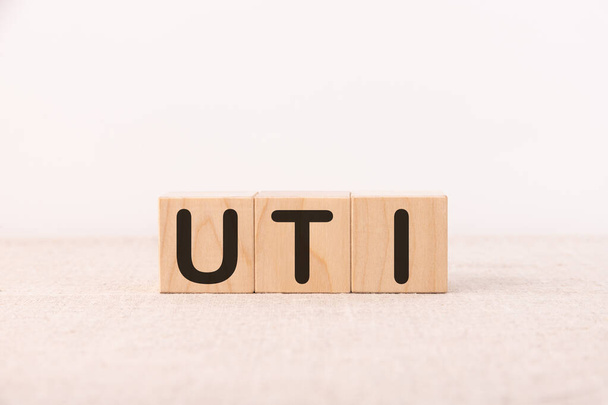 UTI - acronym from wooden blocks with letters, abbreviation UTI urinary tract infection. - 写真・画像