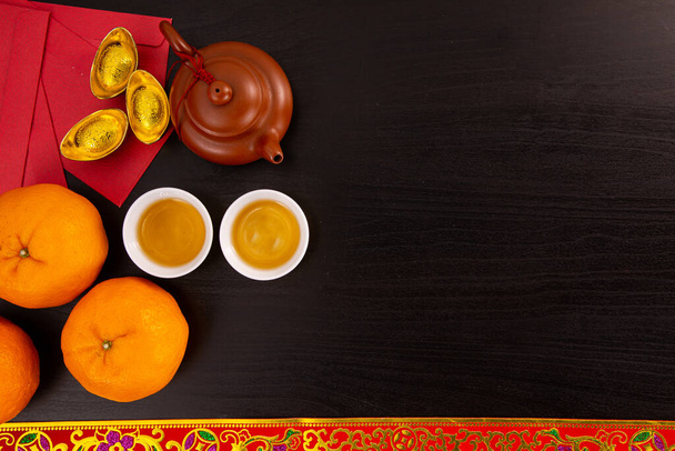 Flat lay Chinese new year mandarin orange and tea water with top view Copy space  for celebrate china festival.hinese characters ZHAO CAI JIN BAO in the article refer to lucky fortune ,wealth, rich - Photo, image