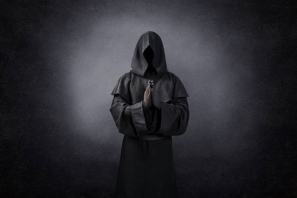 Ghostly figure praying in the dark - Φωτογραφία, εικόνα