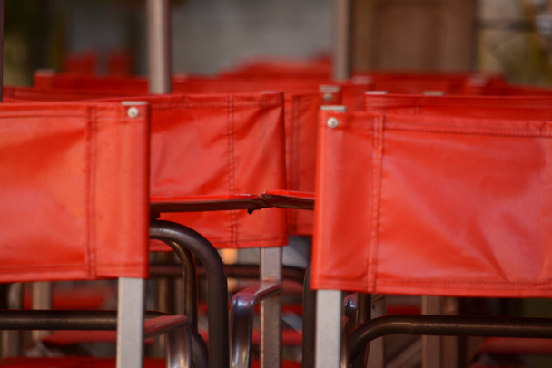 red stacked food business chairs stored by closure - Photo, Image
