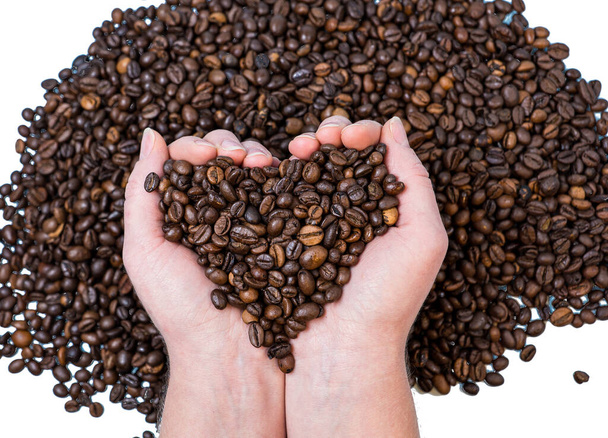 kávébab közelkép a tenyér alakú szív háttér más kávébab - Fotó, kép