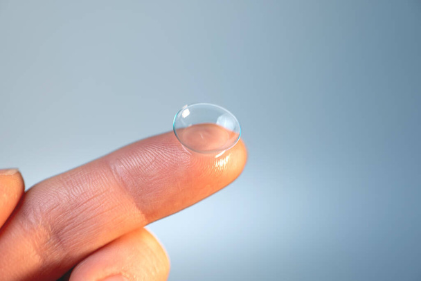 contact lens on the finger on a light background - Photo, Image