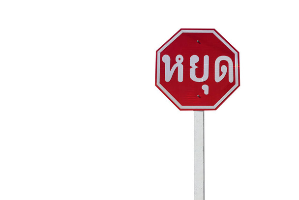 Verkeersbord; geïsoleerd stopbord op paal met knippaden. Thaise taal op de foto is 'STOP' in het Engels. - Foto, afbeelding