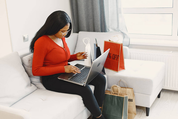 African woman online shopping at home - Fotoğraf, Görsel