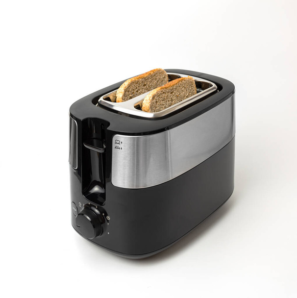 Black-gray toaster with toast on white background isolated - Photo, Image