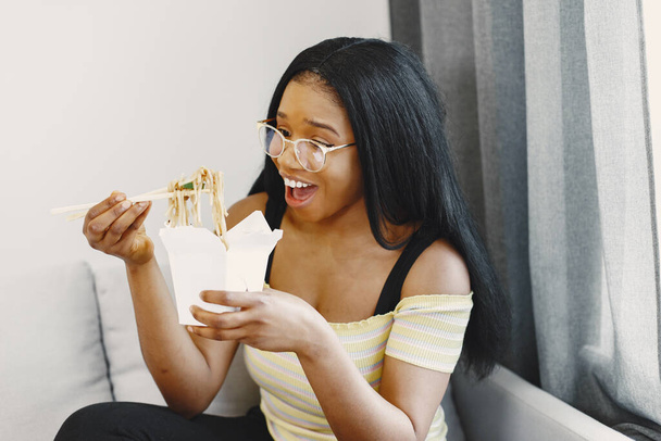 Beautiful young african american woman eating noodles - Fotoğraf, Görsel
