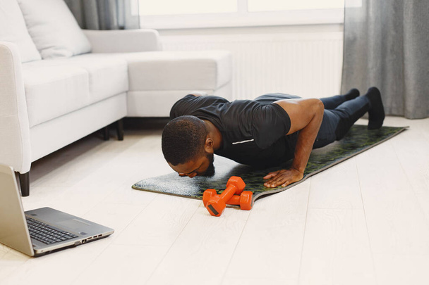 Handsome Afro American sportsman working out at home - Fotoğraf, Görsel