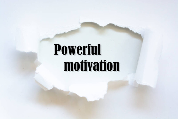 Powerful motivation word written under torn paper concept. - Photo, Image
