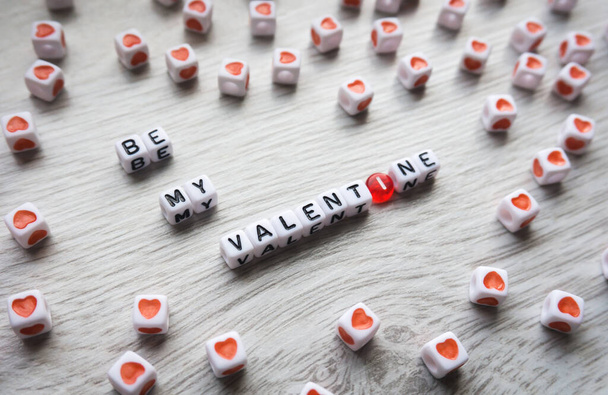 Be my Valentine sign made of white plastic letters beads surrounded by hearts. Valentines day background - Photo, Image